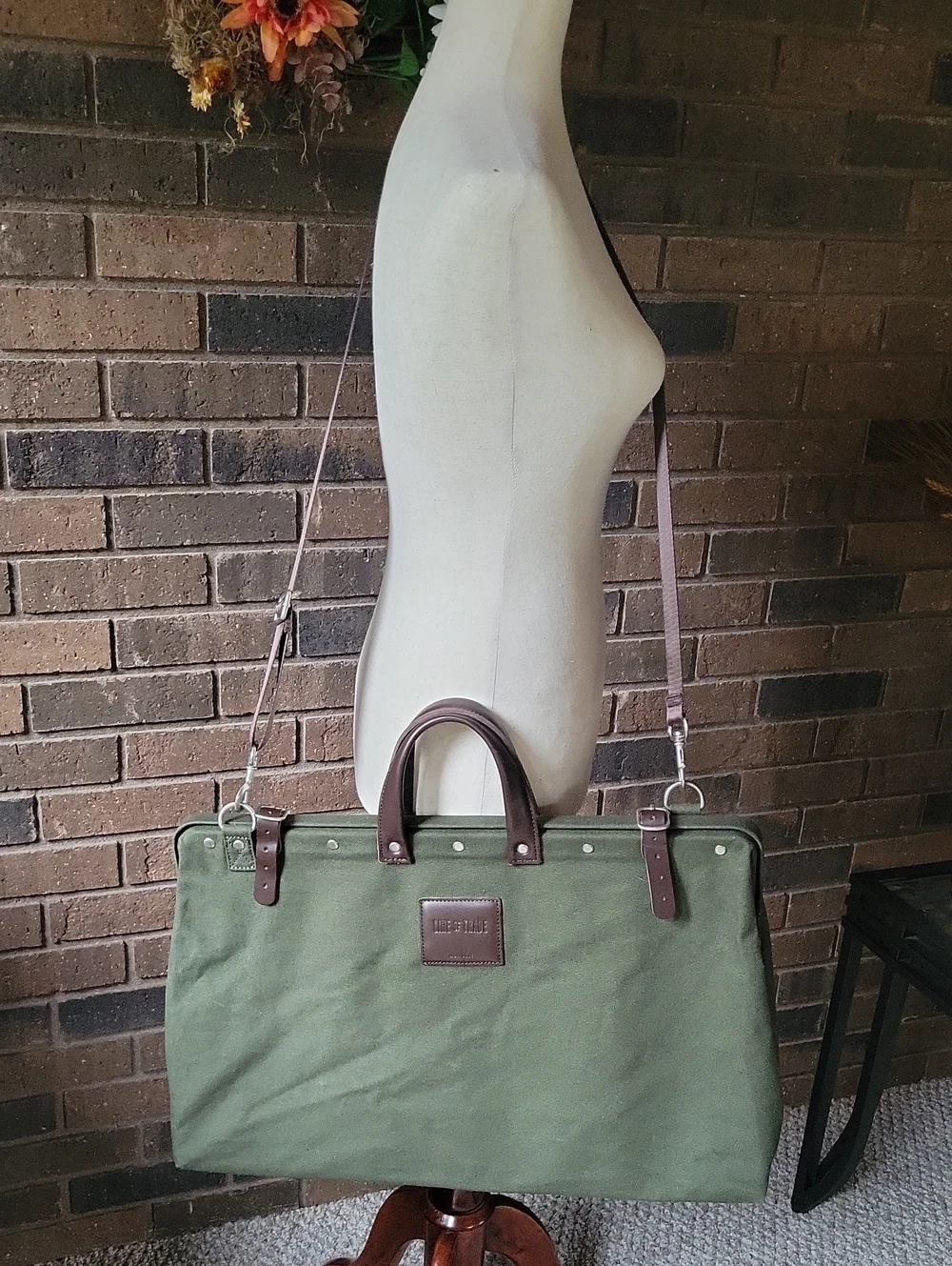 Line of Trade green military duffle sack with brown canvas strap